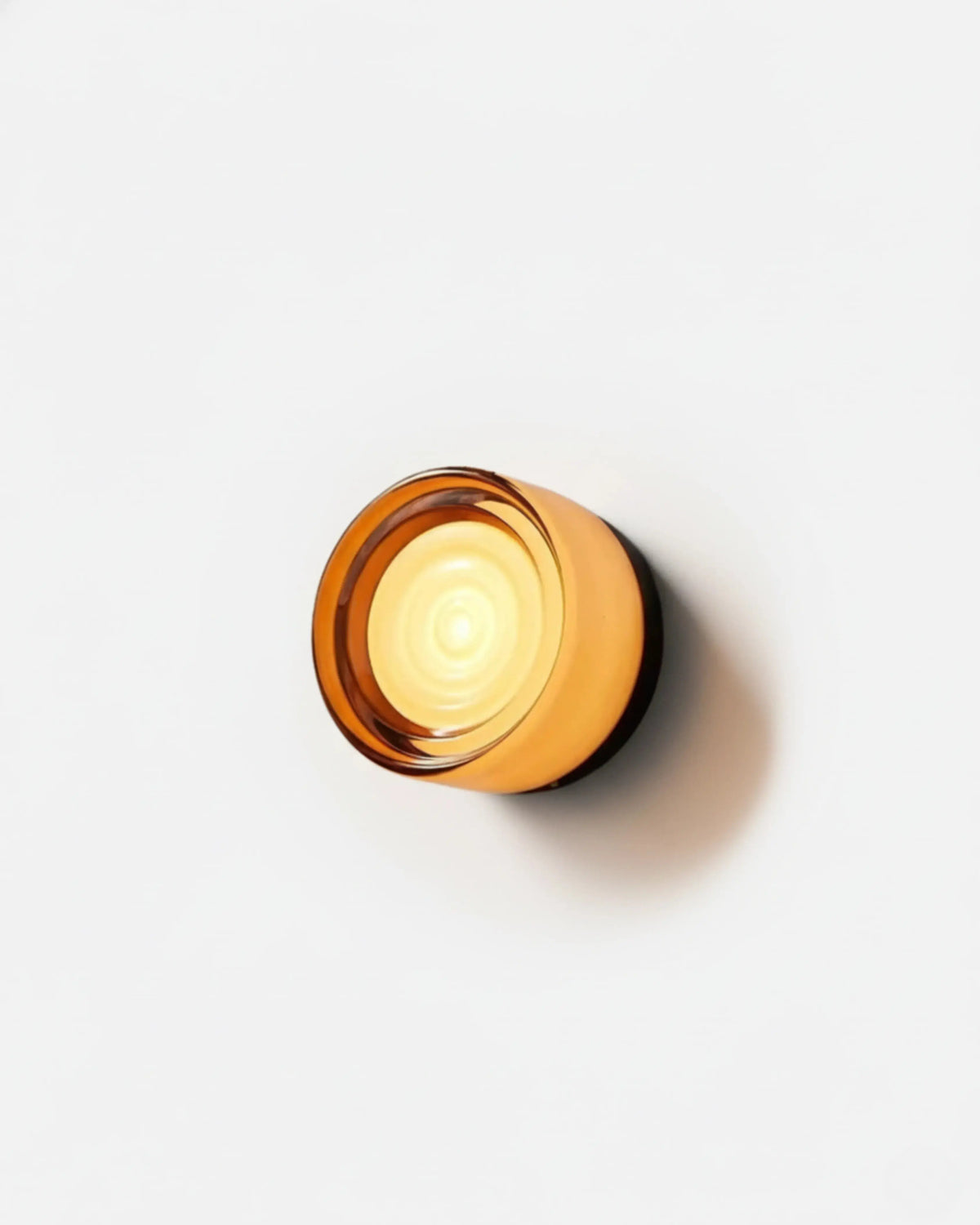 Orla round LED wall light with amber ripple shade