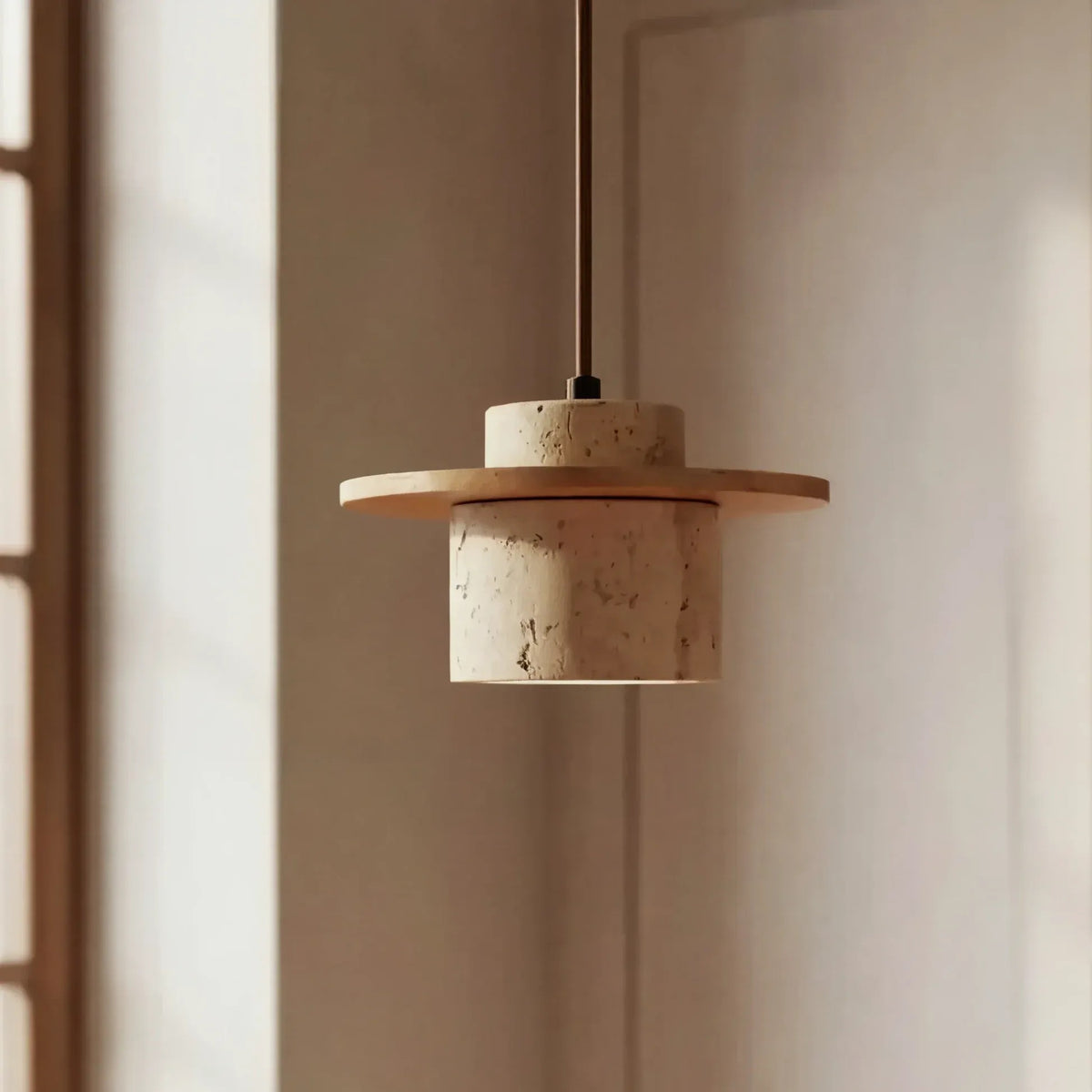Avra travertine pendant light with natural wood ring in soft window light