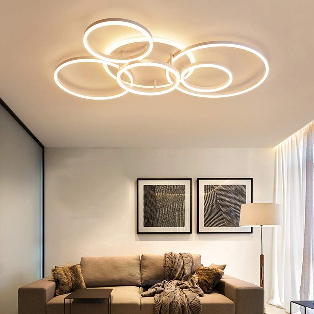 Circle 6-ring LED flush mount ceiling light in white, soft warm glow above a beige living room sofa