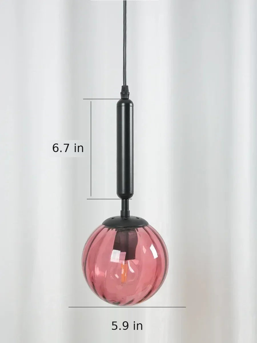 Coco pendant light dimensions in inches: 5.9 in glass globe, 6.7 in stem, shown with black stem and pink glass