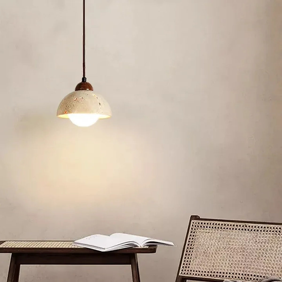 Cora travertine dome pendant light above a reading chair