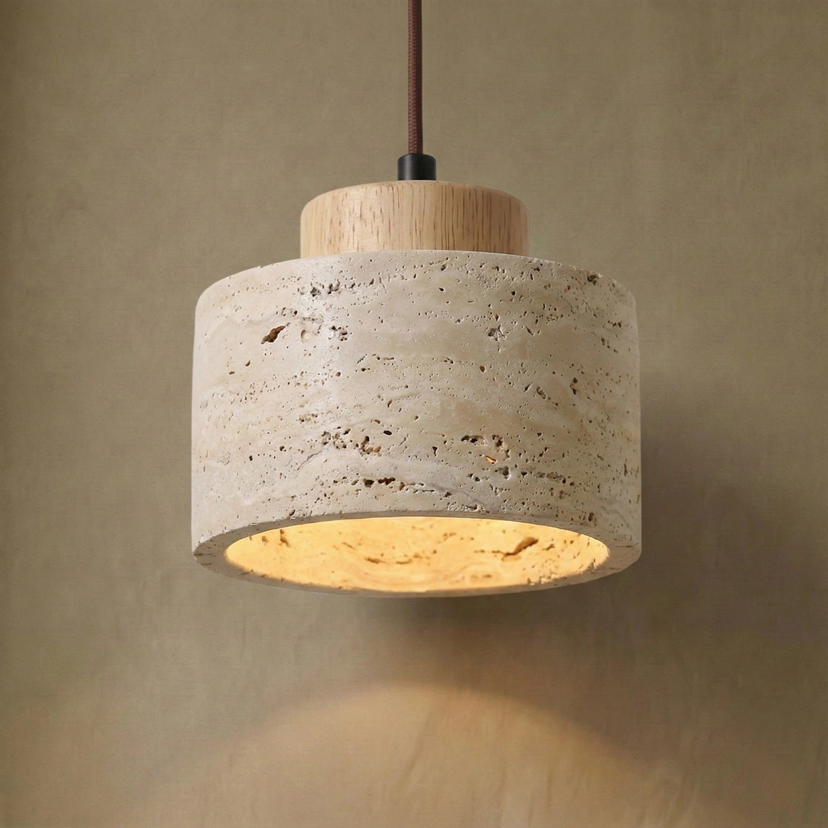 Close-up of the Cora travertine drum shade and light wood cap