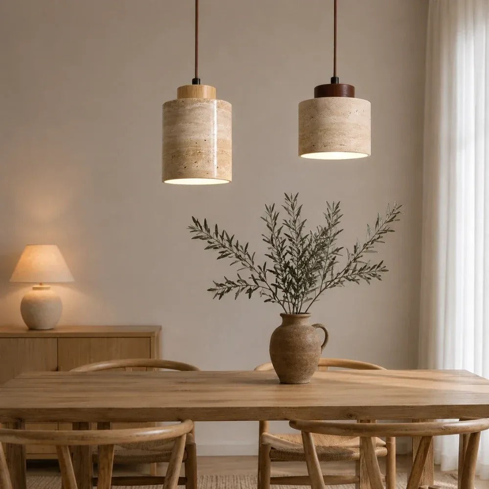 Cora travertine pendant lights in light wood and walnut above a wood dining table