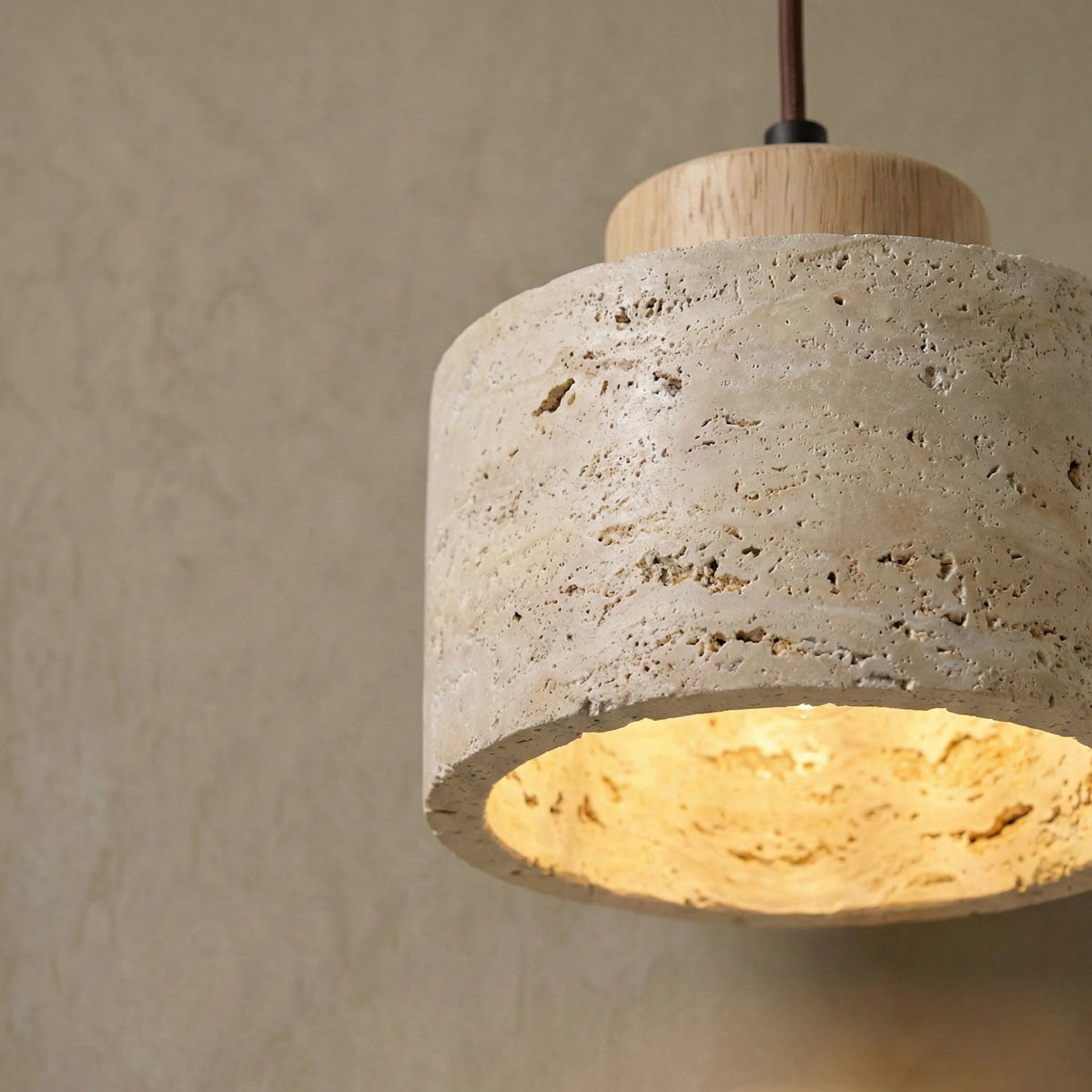 Close-up of the natural travertine pores on the Cora pendant shade