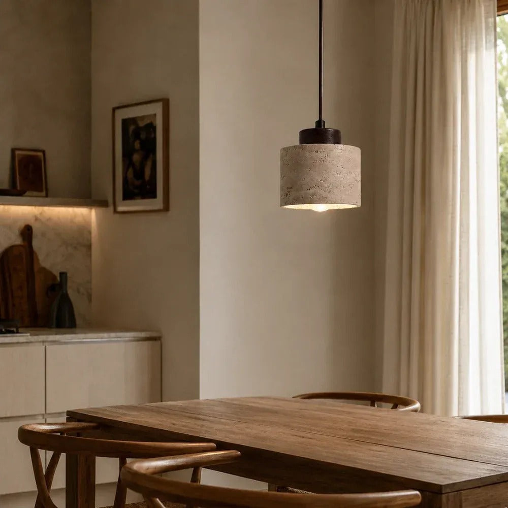 Cora travertine drum pendant light with a walnut cap above a dining table