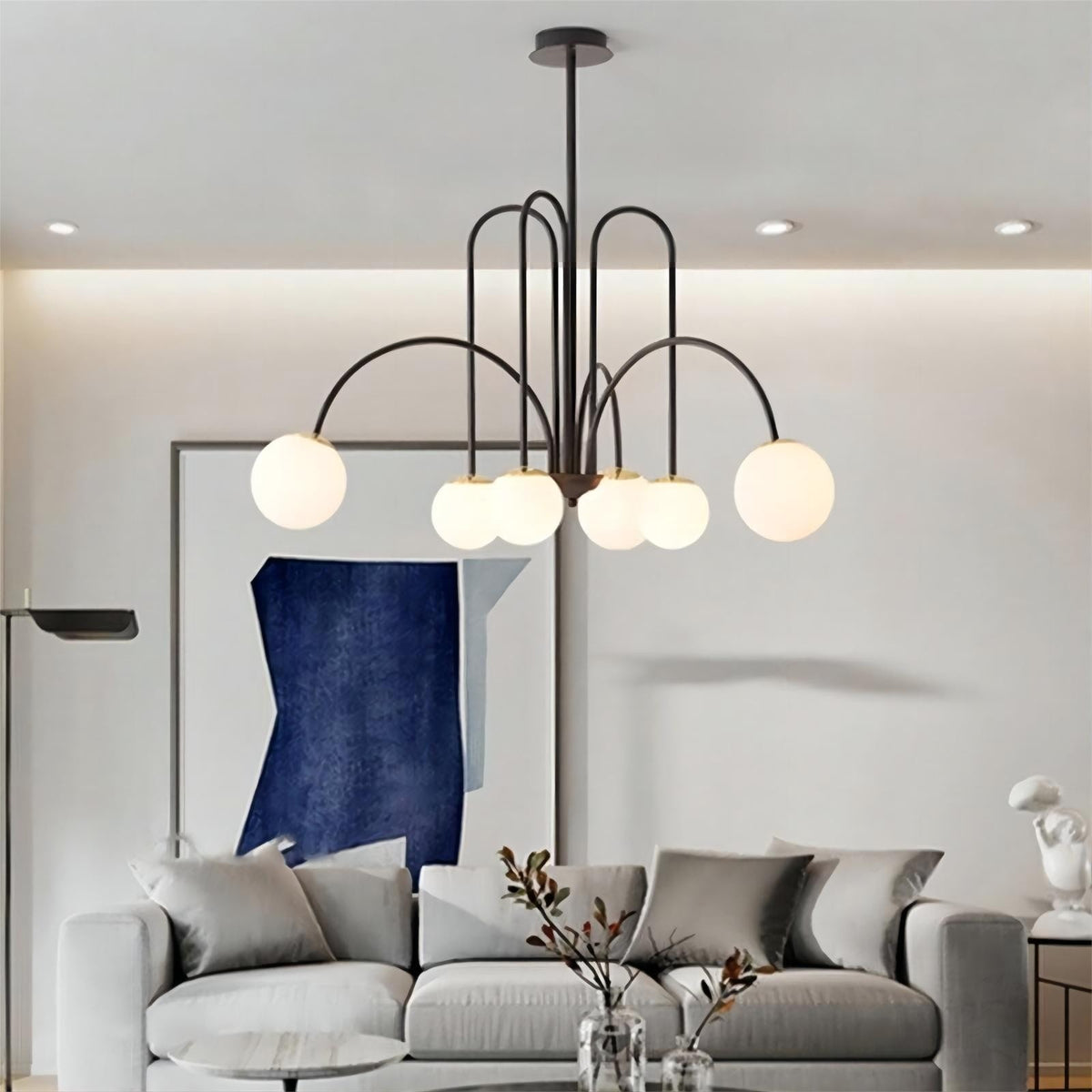 Elara arched globe chandelier in black above a sofa