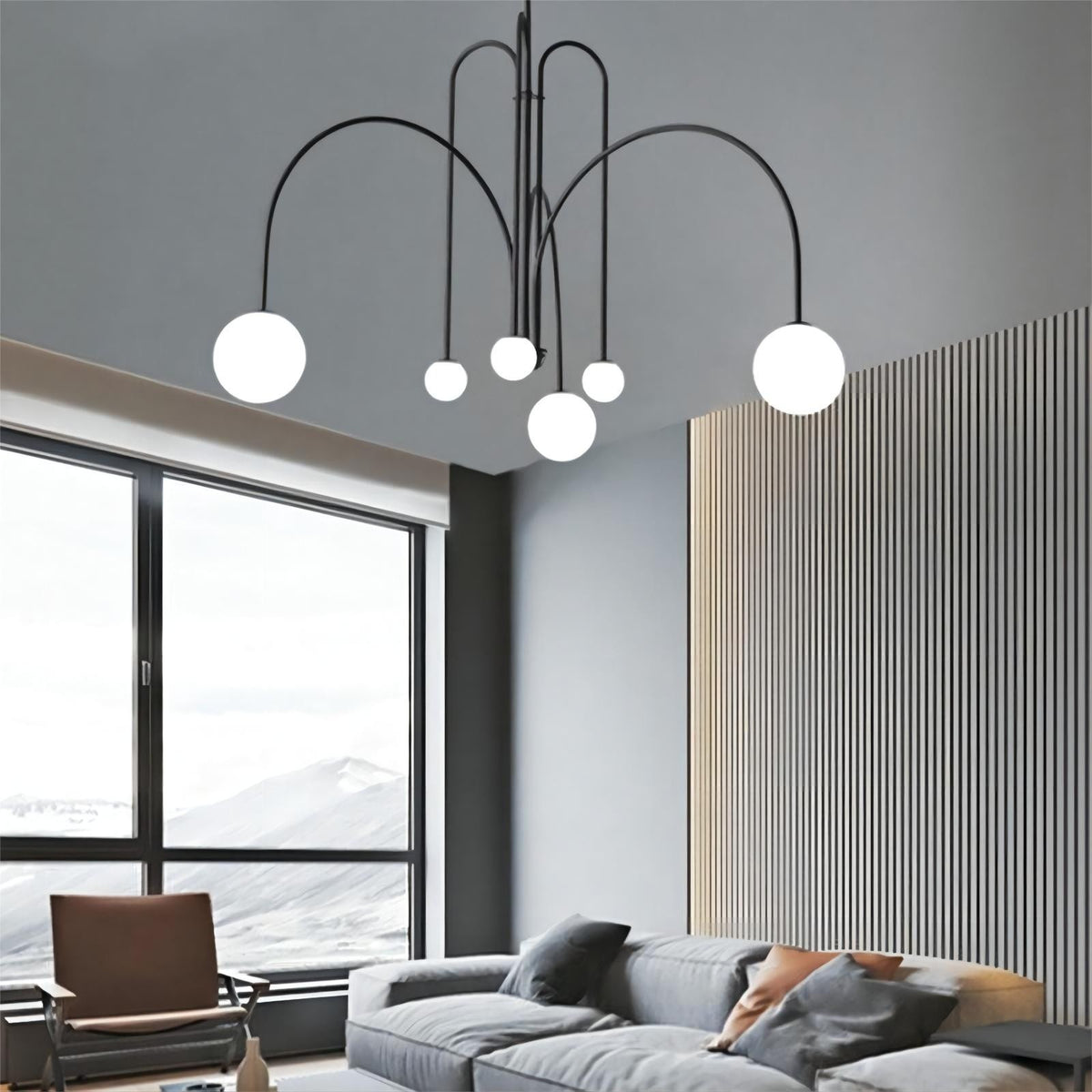 Elara arched globe chandelier in black under a high ceiling by a window