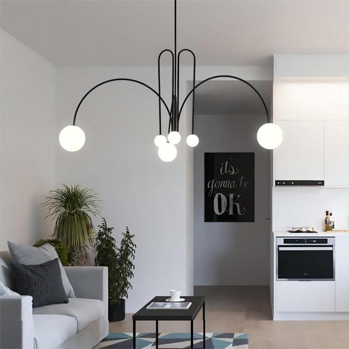 Elara arched globe chandelier in black in an open-plan living room