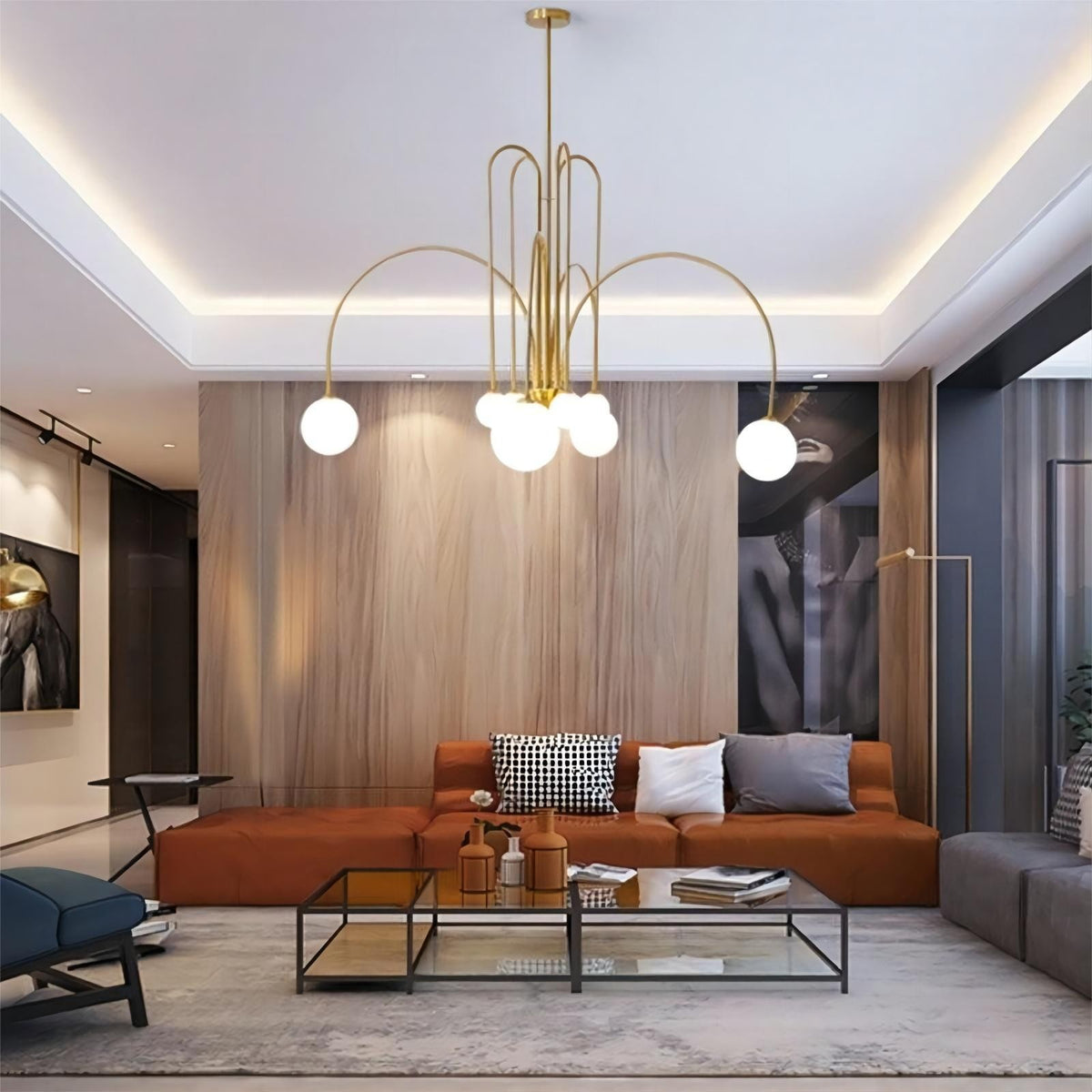 Elara arched globe chandelier in gold in a living room