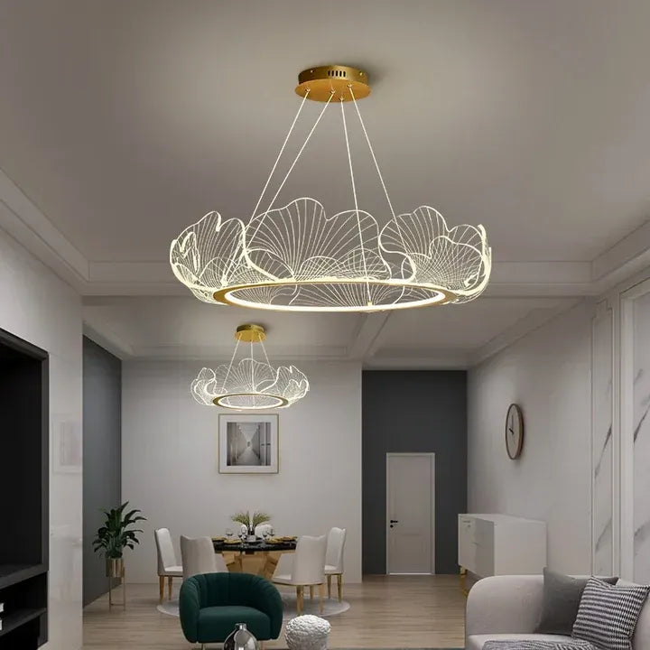 Elara gold acrylic ginkgo leaf chandeliers in an open living and dining room