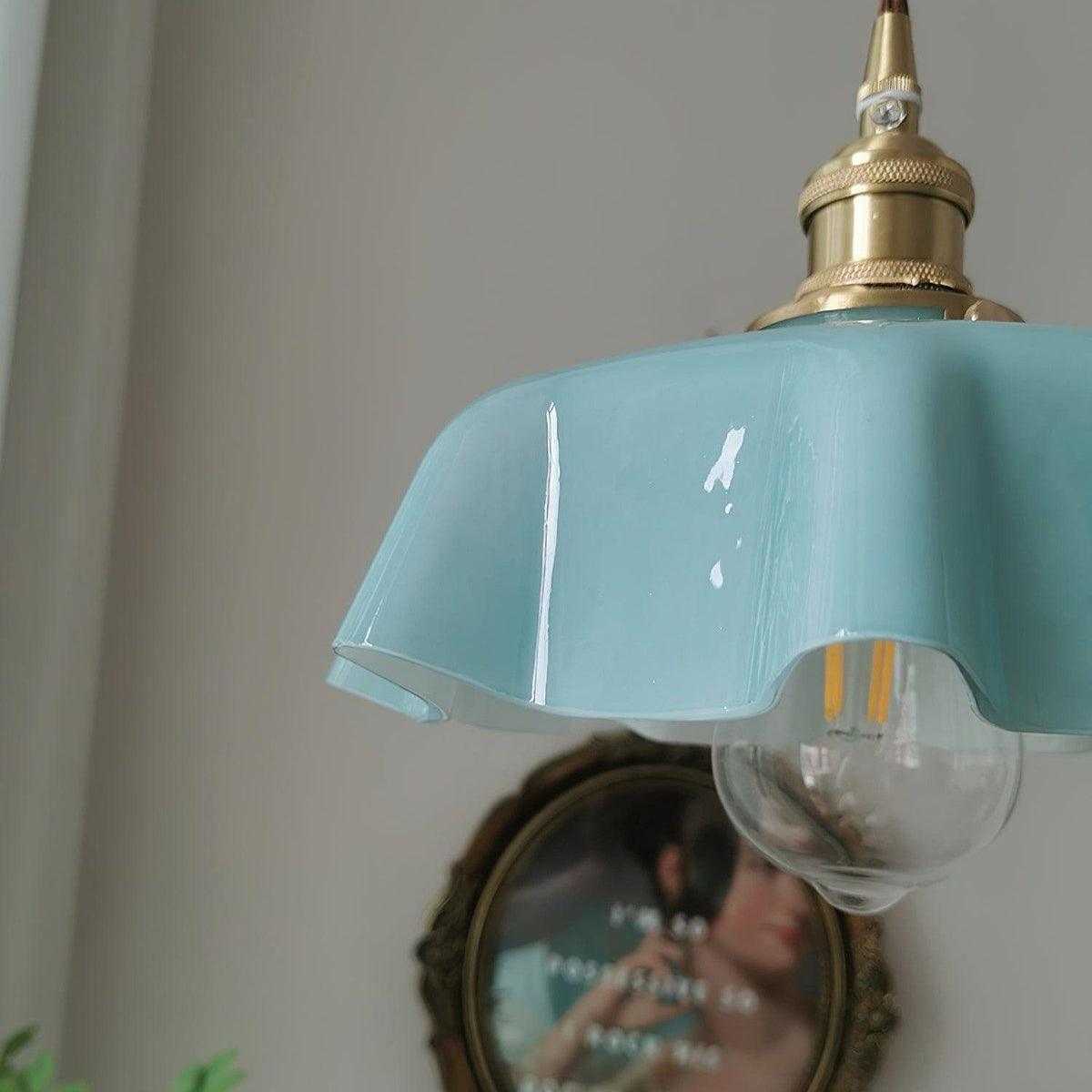 Close-up of the Fleur blue scalloped glass shade and brass socket