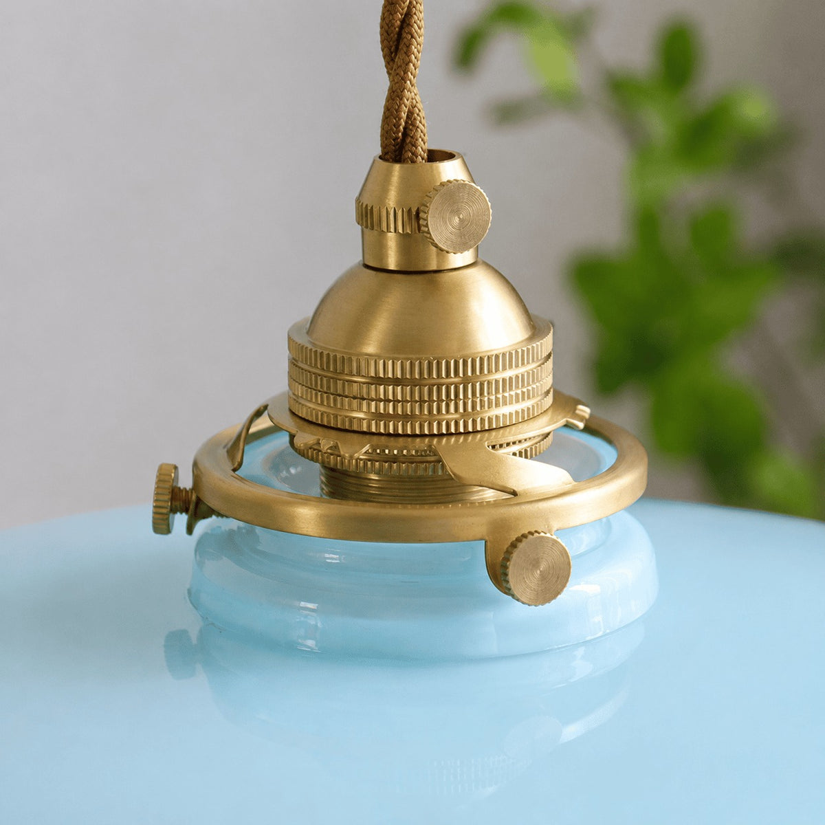 Brass socket with knurled ring on the Fleur glass pendant light