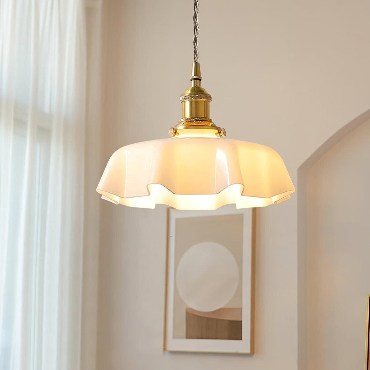 Fleur cream scalloped glass pendant light glowing in an arched alcove