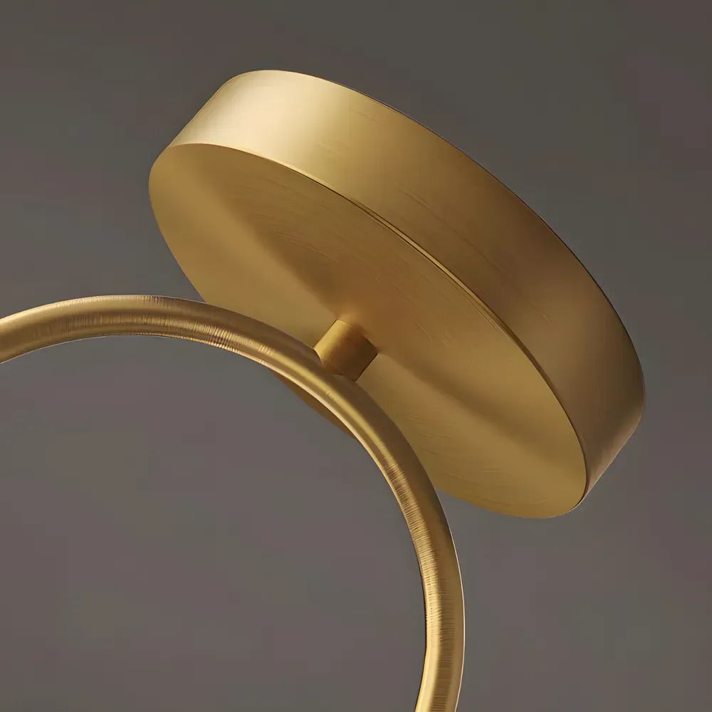 Brass canopy and curved arch of the Gemma ceiling light