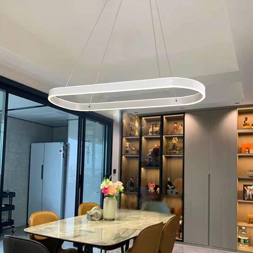 Halo oval LED pendant light in white over a dining table