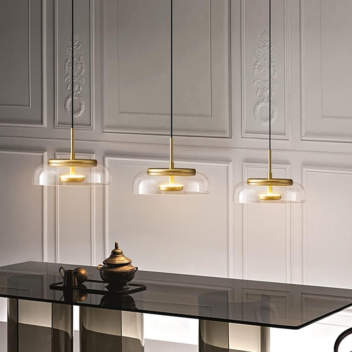 Three Ivy clear glass bowl pendant lights over a dining table