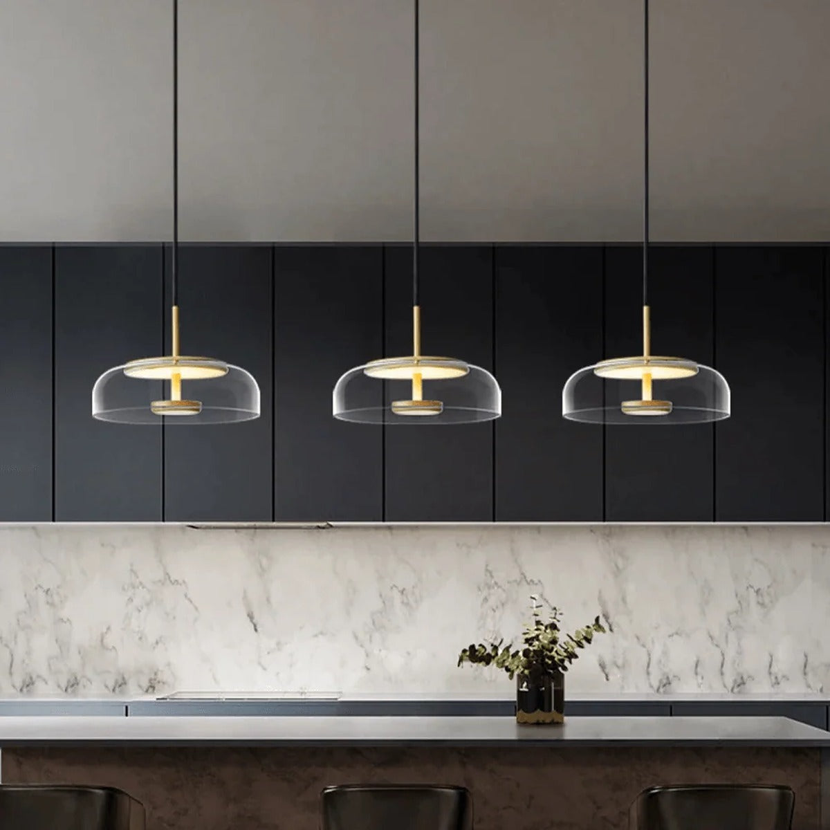 Three Ivy clear glass LED pendant lights over a kitchen island
