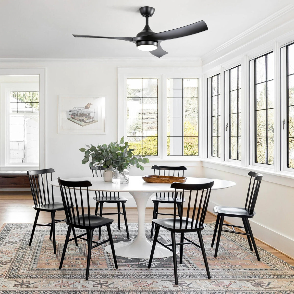 Kestrel 52 in black ceiling fan with light above a dining table