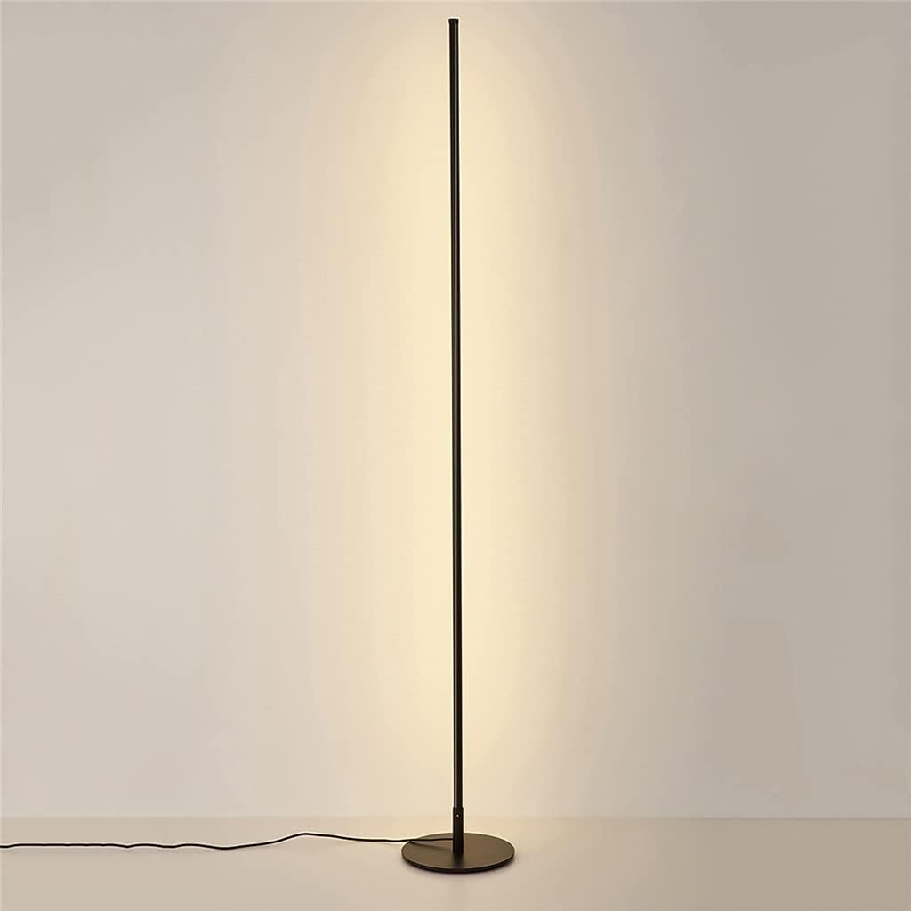 Linear Slim black LED floor lamp casting a warm indirect glow on the wall