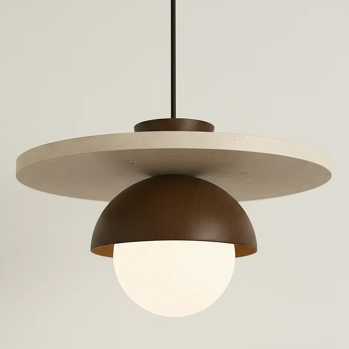 Close-up of the Luna travertine disc, wood dome and opal glass globe
