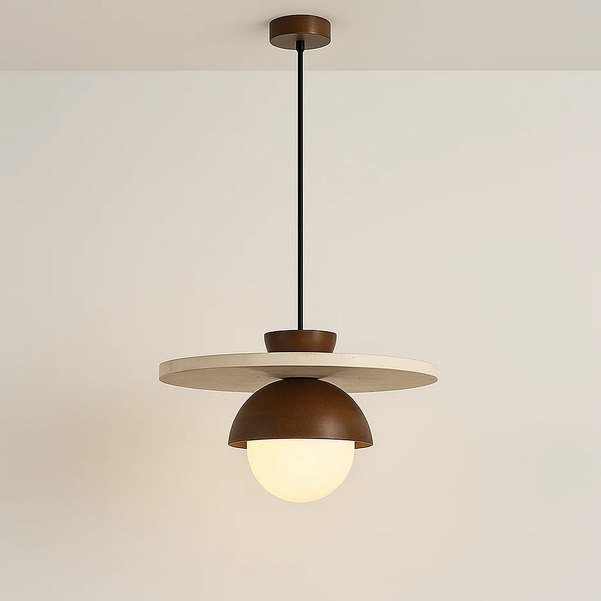 Luna pendant light switched on, with a soft glow from the opal glass globe