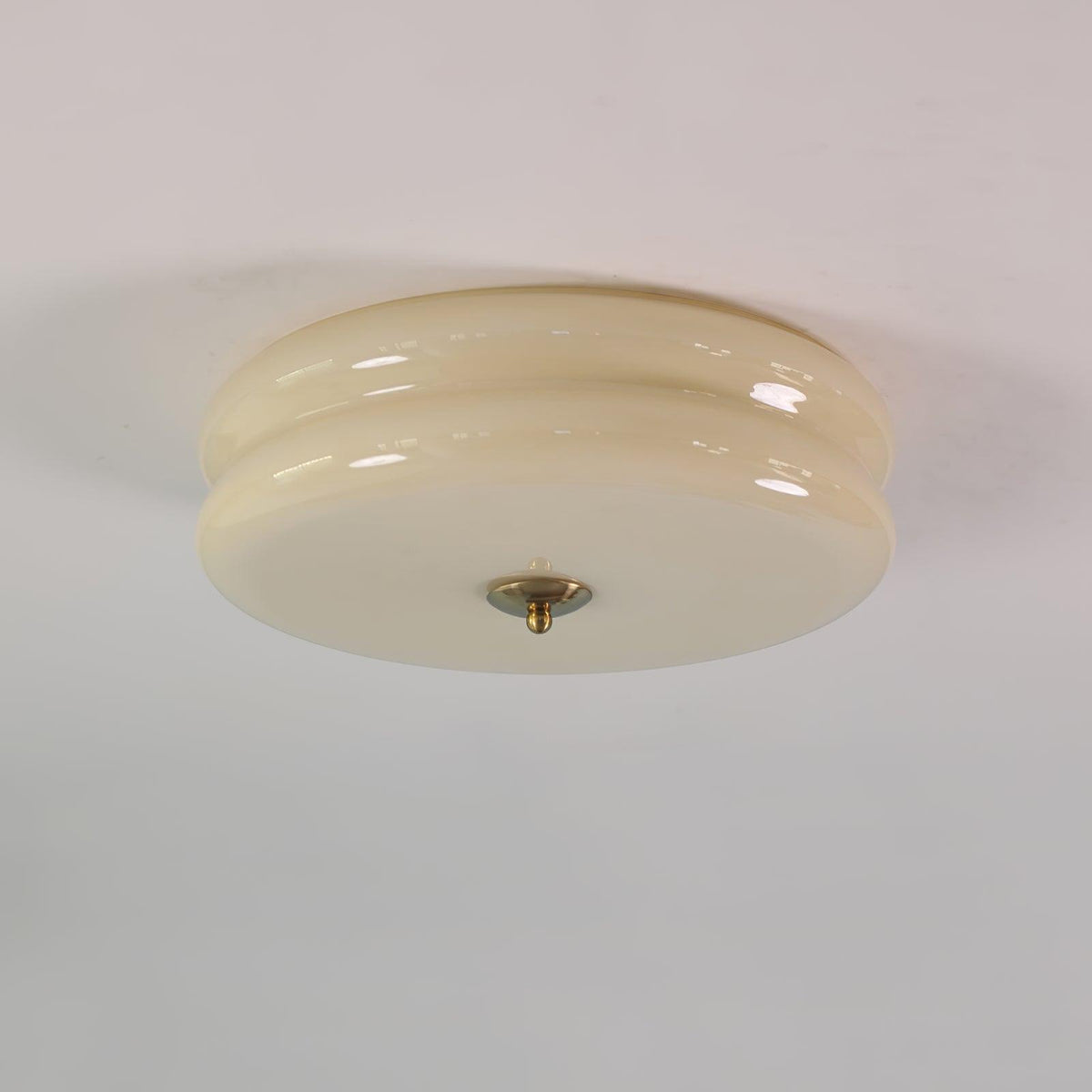 Margot flush mount ceiling light, beige glass with gold finial