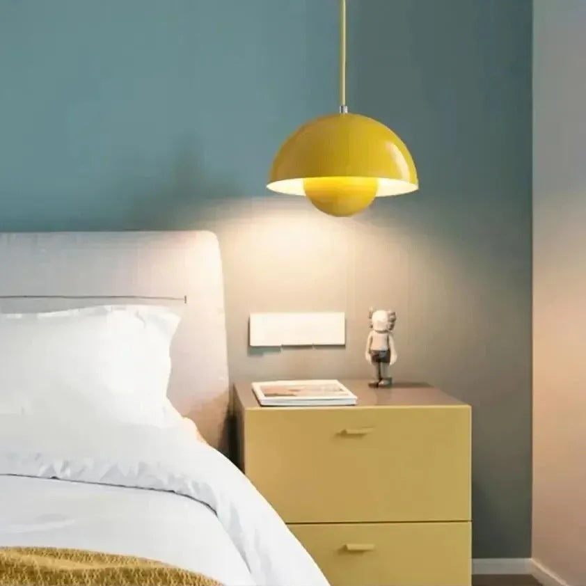 Yellow Nola mushroom pendant light hanging over a bedside table