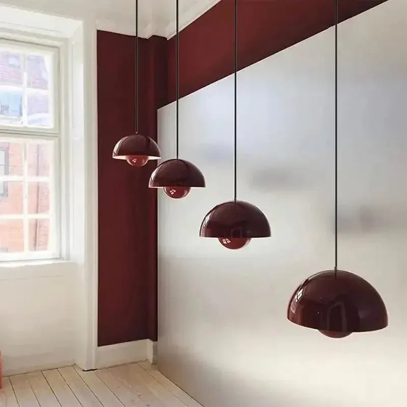 Row of red Nola mushroom pendant lights in a bright hallway