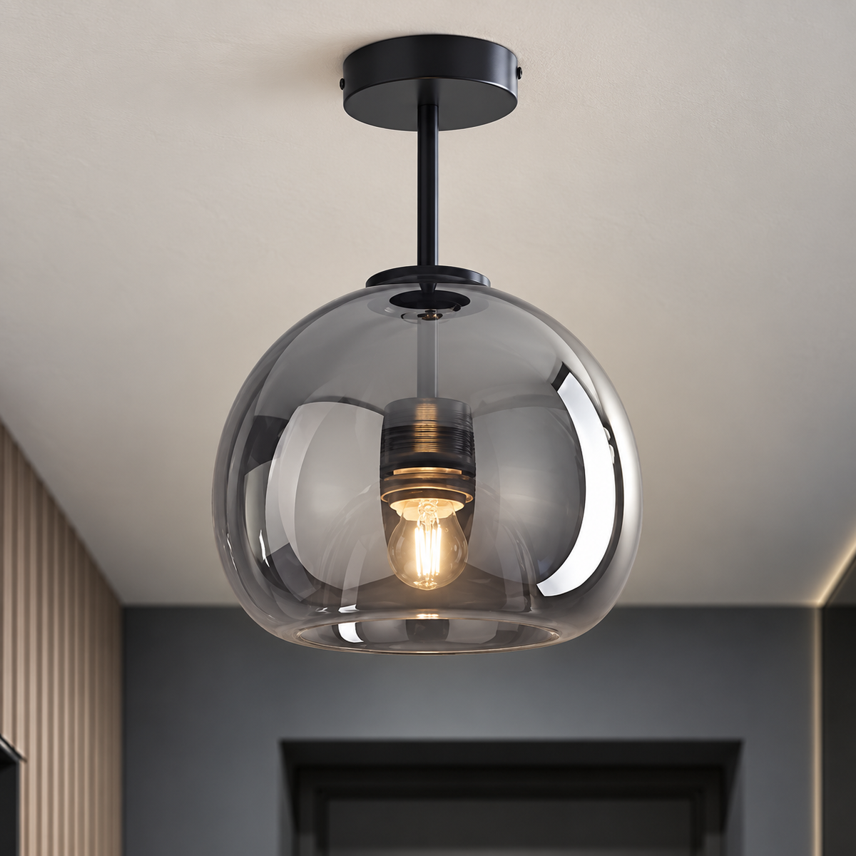 Detail of the Oren black ceiling canopy and straight stem with a rounded smoke-gray glass shade