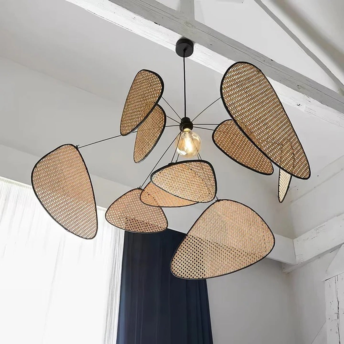 Large Palma rattan petal pendant light hanging from a vaulted ceiling