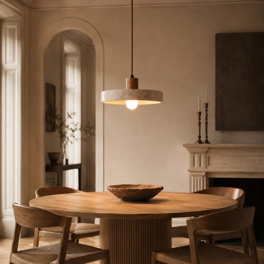 Runa travertine disc pendant light over a round dining table