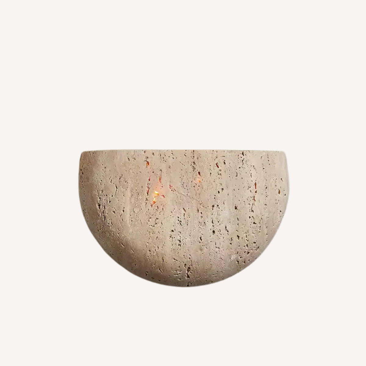 Sora half-moon travertine wall sconce casting a warm glow