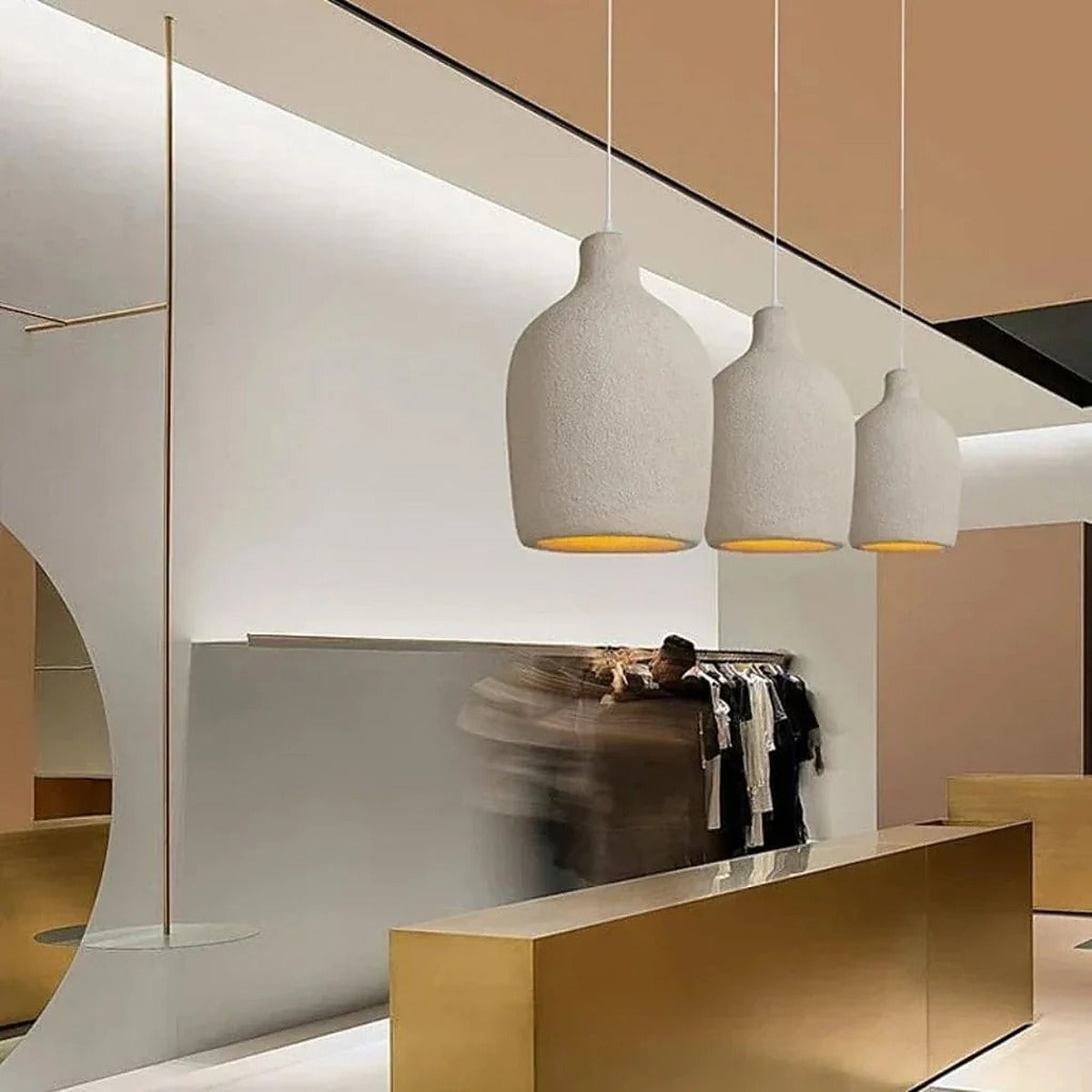 Row of Suna wabi-sabi pendant lights over a counter