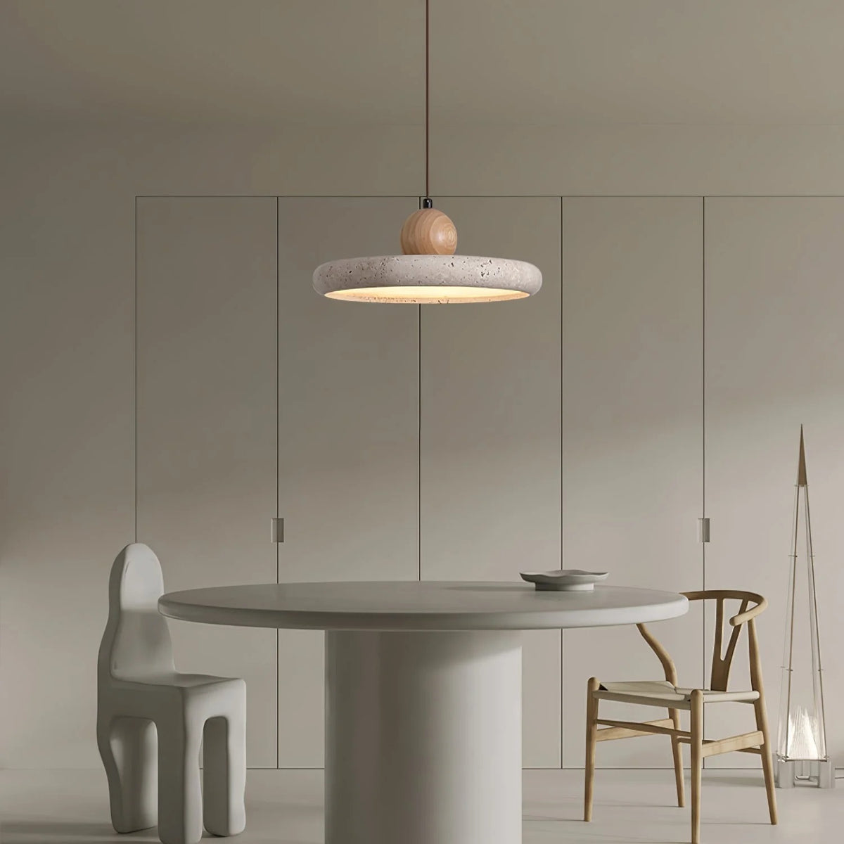 Terra travertine disc pendant light over a round white table