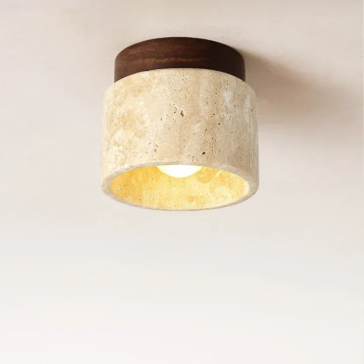Illuminated Tova ceiling light with a beige travertine shade and walnut finish wood base