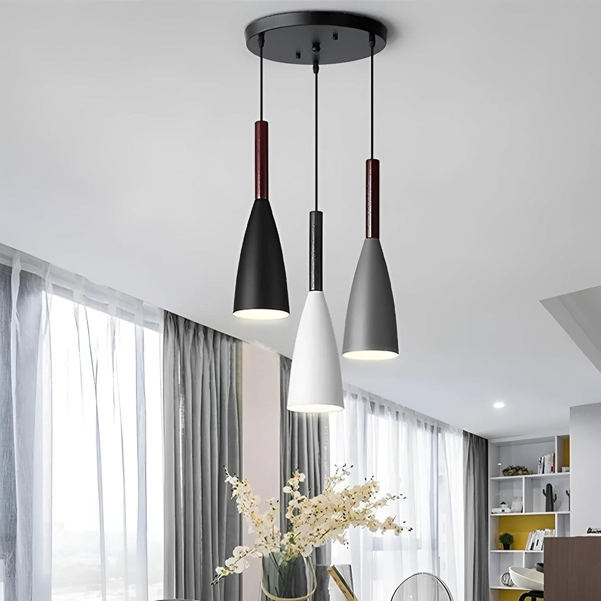 Vika 3-light cluster pendant in mixed black, white and gray above a dining area by a window