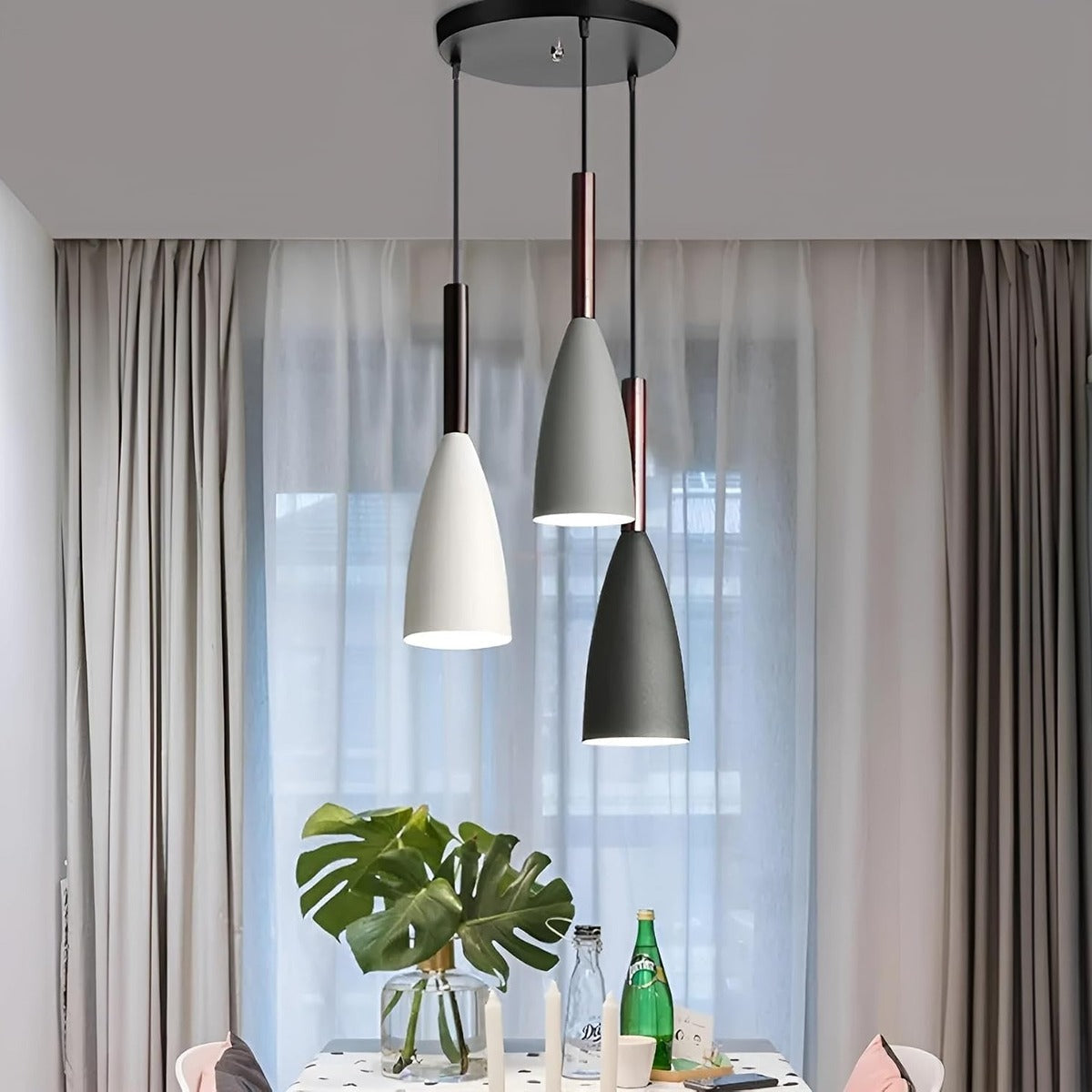 Vika 3-light round pendant with staggered heights in front of sheer curtains