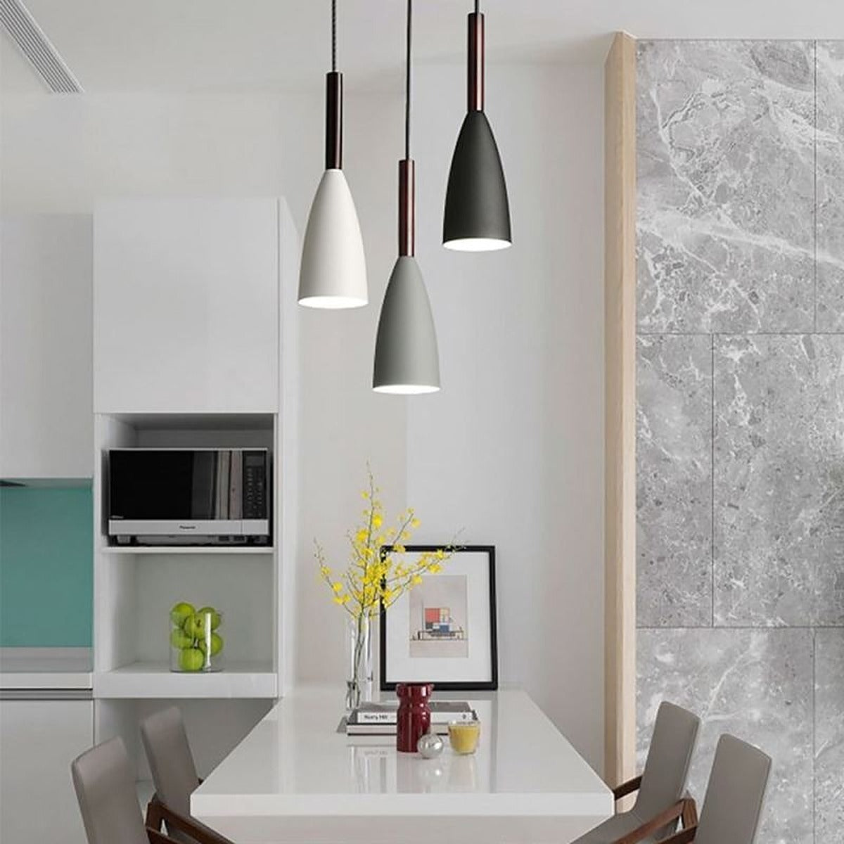 Single Vika slim pendant lights in white, gray and black above a white kitchen counter